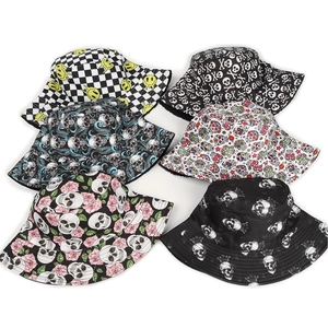 Flat lay of bucket hats featuring skull, rose, and checkerboard print designs