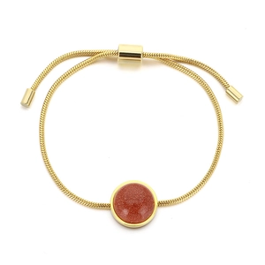 Adjustable snake chain gold bracelet with shimmering reddish-brown round sandstone