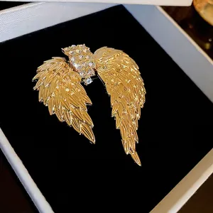 Luxurious gold angel wings brooch with sparkling rhinestones in a premium jewelry gift box