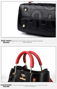 Detail of embossed leather handbag showing bottom gold rivets and red handle stitching