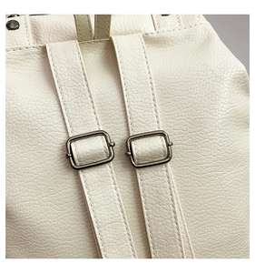 Detail of white lychee grain leather straps with adjustable square metal buckles