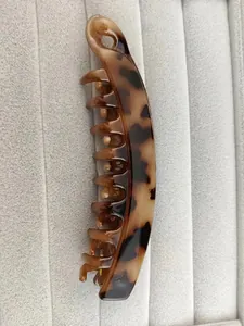 Detailed close-up of a large banana hair clip with classic leopard tortoise pattern