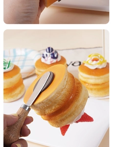 Close-up of realistic PU fruit cake fridge magnet with cream and a small palette knife