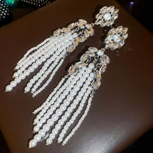 Close-up of floral crystal stud with elegant long pearl tassel waterfall earring design