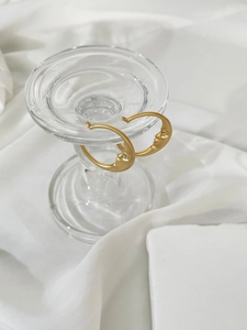 Detailed view of gold crescent moon face earrings with micro-inlaid sparkling zircon