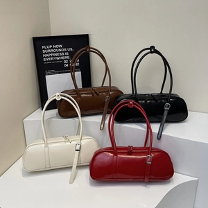 Retro baguette shoulder bag in four colors with glossy finish on a white display stand