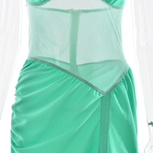 Detailed close-up of mint green sheer mesh stitching and ruched fabric seams on dress