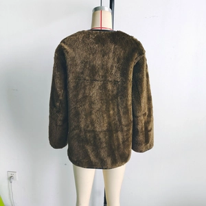 Rear view of brown plush long sleeve coat on mannequin with focus on texture and back cut