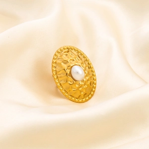 Detail of 18K gold-plated stainless steel flower ring with pearl on beige silk