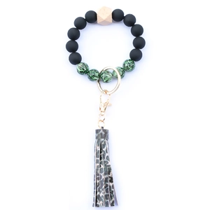Detail of beaded keychain bracelet with leopard print tassel and wooden hex bead