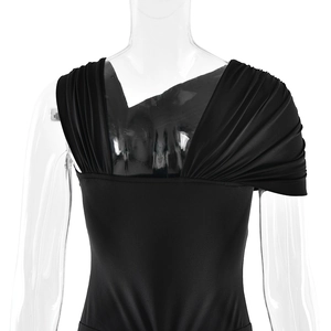Detail of elegant black slim-fit dress featuring ruched shoulder and draped design