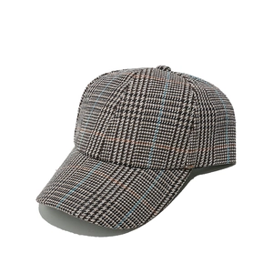 Detail of vintage glen check baseball cap with brown and blue woven plaid fabric texture