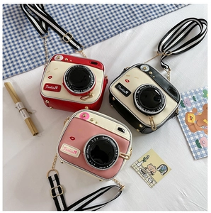 Three cameras-shaped PU leather crossbody bags in red, black, and pink with chain straps