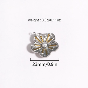 Macro view of a 23mm floral pendant with silver petals, gold accents, and a white pearl