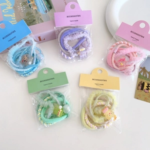 Set of 5 colorful floral elastic hair ties in blue purple pink green and yellow