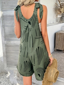 Back view of green bohemian halter romper with shell patterns and tie-up shoulder straps