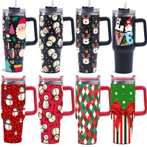 Multiple 40oz stainless steel tumblers with diverse Christmas patterns and sturdy handles
