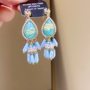 Close-up of S925 silver water drop tassel earrings with blue crystals and pearls
