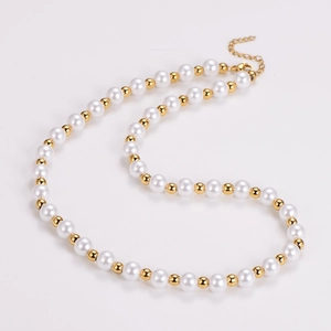 Detail of elegant pearl and gold bead necklace with an adjustable extender chain
