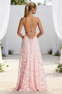 Detail of cross lace-up open back design on a pink floral lace evening dress