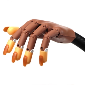 Detailed view of adjustable brown prosthetic hand with yellow nails for nail art practice