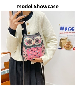 Lifestyle shot of an owl-shaped crossbody bag featuring colorful artistic illustrations