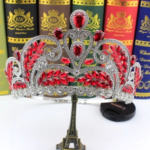Detail of silver bridal crown with red teardrop gems and crystal rhinestones