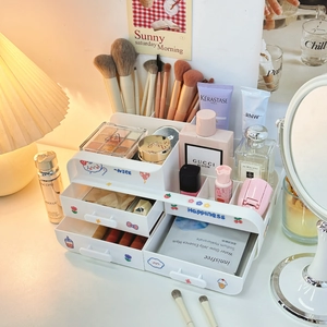 Close-up of a white multi-layer desk organizer with drawers and cute cartoon stickers
