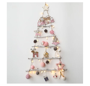 Detail of DIY wall Christmas tree with pink ornaments, plush sheep and warm LED lights