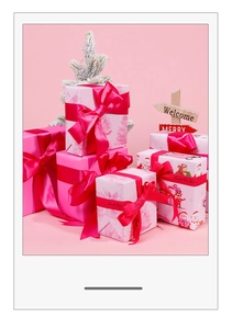Detail of pink Christmas wrapping paper with snowmen patterns and satin ribbons