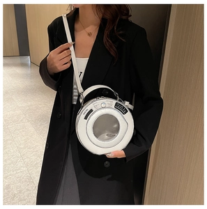 Detail of unique white circular handbag with creative washing machine design and clear window