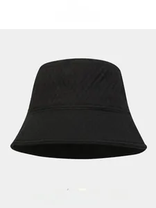 Close-up of black bucket hat with diamond quilted texture and foldaway design