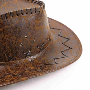 Detail of vintage cowboy hat featuring distressed texture, X-shaped hand stitching and eyelets