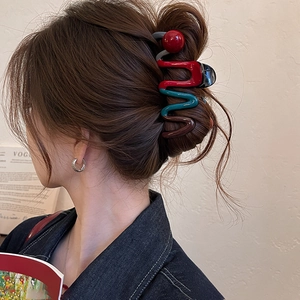 S-shaped color-block hair claw clip with large wave design and red ball accent