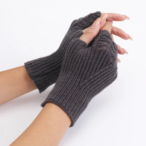 Close-up of charcoal grey knit fingerless gloves with scale pattern texture
