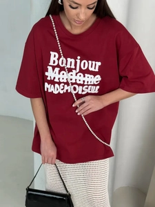 Detail of red oversized cotton T-shirt featuring white Bonjour Madame textured lettering