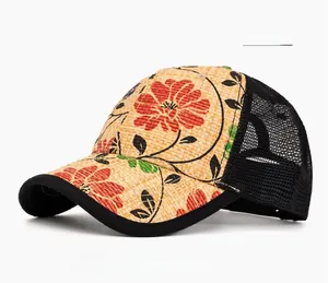 Detail of straw baseball cap featuring red floral prints and breathable black mesh fabric