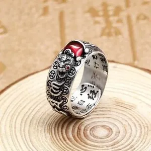 Macro shot of S925 silver ring featuring red gemstone and engraved Heart Sutra scripture