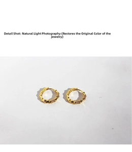 Detailed shot of bamboo texture gold earrings with micro-set white cubic zirconia stones