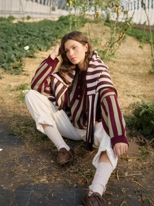 Outdoor vintage style striped knit sweater with buttons and shawl in cozy farm setting