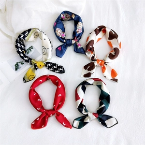 Five assorted vintage printed square scarves featuring patterns like houndstooth and geometric