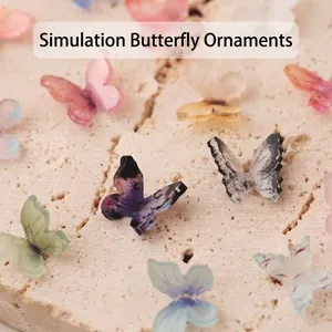 Colorful 3D butterfly nail art charms and DIY jewelry accessories on stone surface