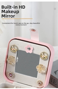 Close-up of pink jewelry box featuring built-in high-definition mirror and earring storage