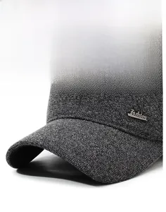Close-up of gray knitted baseball cap with curved brim and Fashion metal emblem