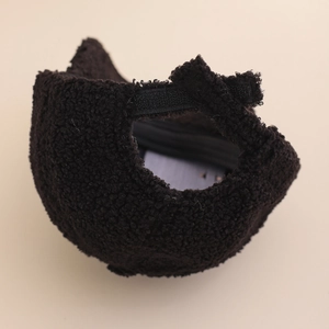 Detail of the brown teddy fleece baseball cap showing the adjustable velcro strap closure