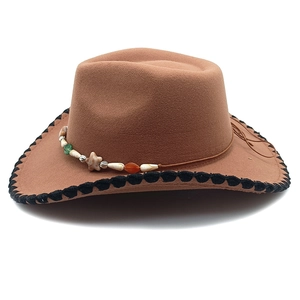 Close-up of brown wool fedora hat featuring colorful bead band and black stitched edge
