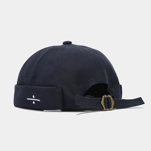 Detail of navy canvas docker hat showing side embroidery and metal back buckle strap