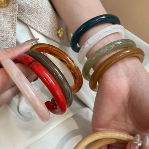 Close-up of resin bangles showing marble textures and diverse vintage colors for women