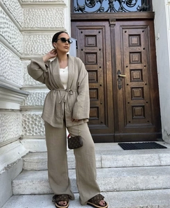 Detail of khaki linen two-piece set featuring waist-tie kimono top and wide-leg trousers