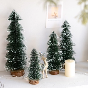 Mini green flocked Christmas trees set with wooden bases for festive tabletop decor